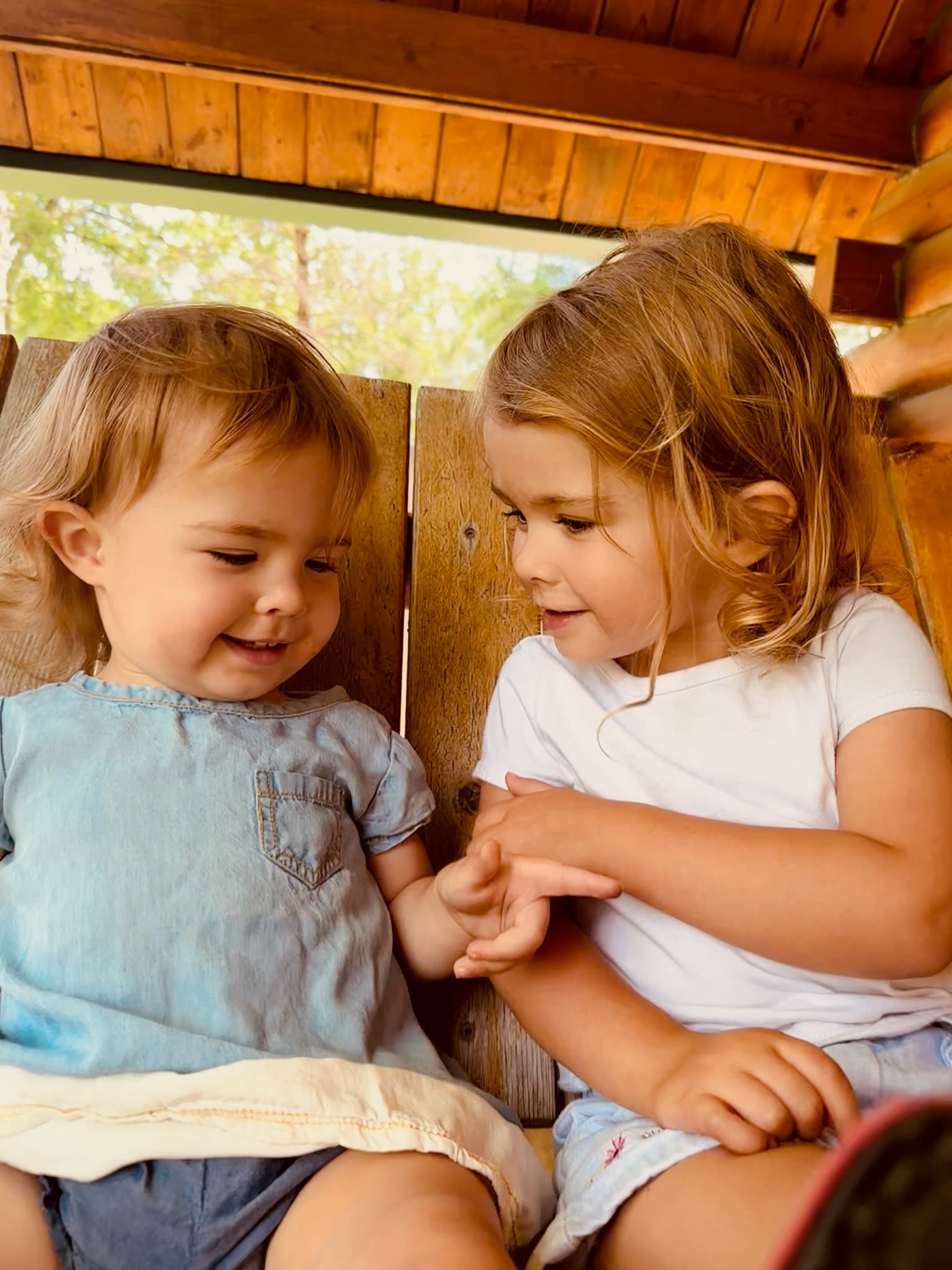 Sisters sharing a moment on the cabin porch